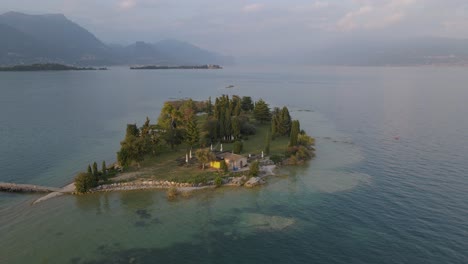 Aerial-view-of-tiny-bar-on-San-Biagio-Island-on-lake-Garda,-northern-Italy