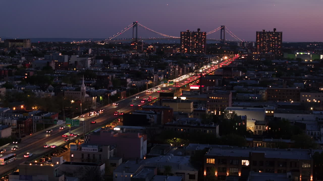 Aerial view of rush hour traffic on Brooklyn's Belt Parkway. Shot at night in Bay Ridge with the Verrazzano Bridge in the background.