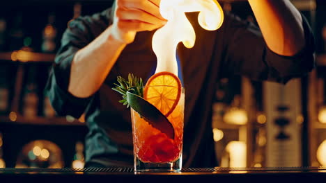 bartender preparing a flaming cocktail at a bar