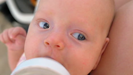 thirsty baby drinking water from the bottle