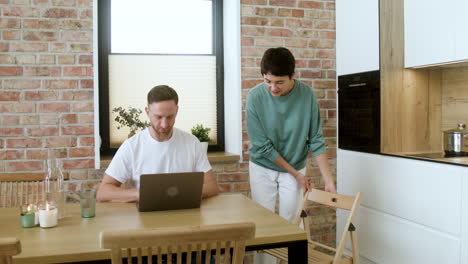 man working on laptop on dining room