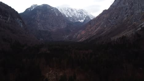 Stunning-aerial-shot-of-valley-surrounded-by-high-Austrian-Mountains-near-Salzburg