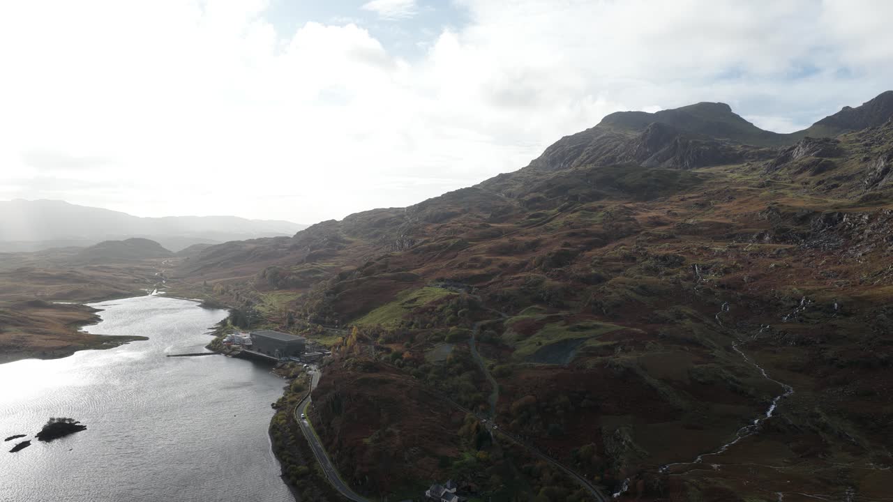 Aerial drone footage of Llyn Cwmorthin and the Moelwyn Mawr range in Eryri National Park, capturing serene lakeside scenery, dramatic Welsh mountains, and the region’s slate-mining heritage