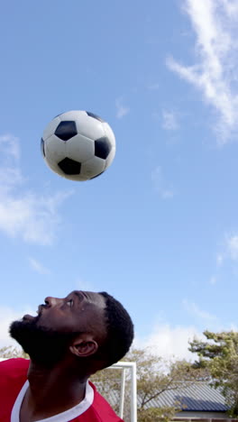vertical video: soccer player focusing on ball control during outdoor practice session