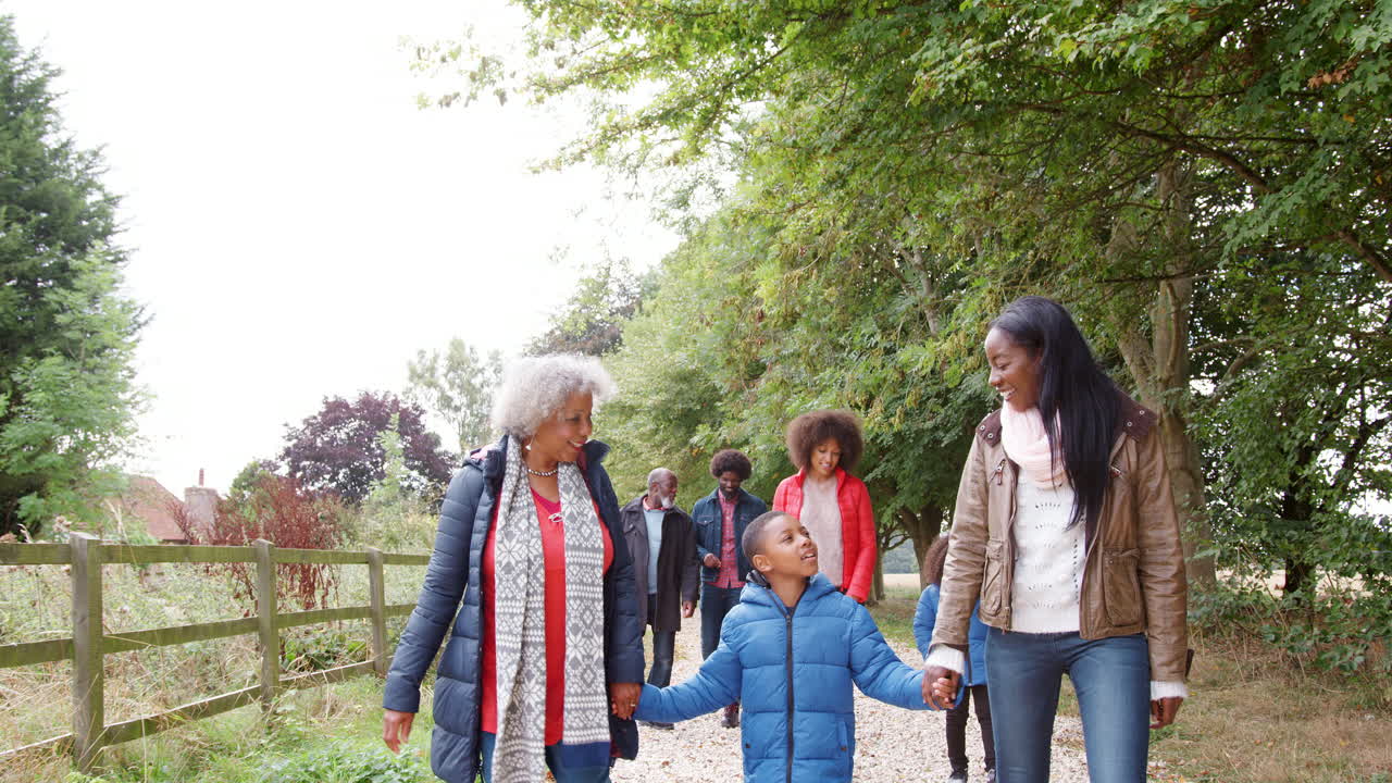 Multi Generation Family On Autumn Walk In Countryside Together