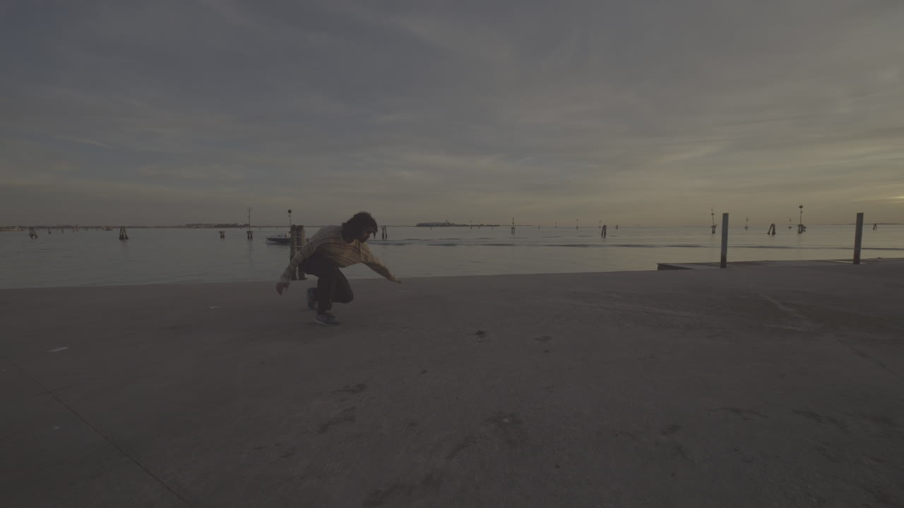 Man performing parkour at sunset in Venice