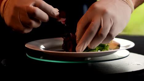 Hands-putting-salad-leaves-on-the-plate