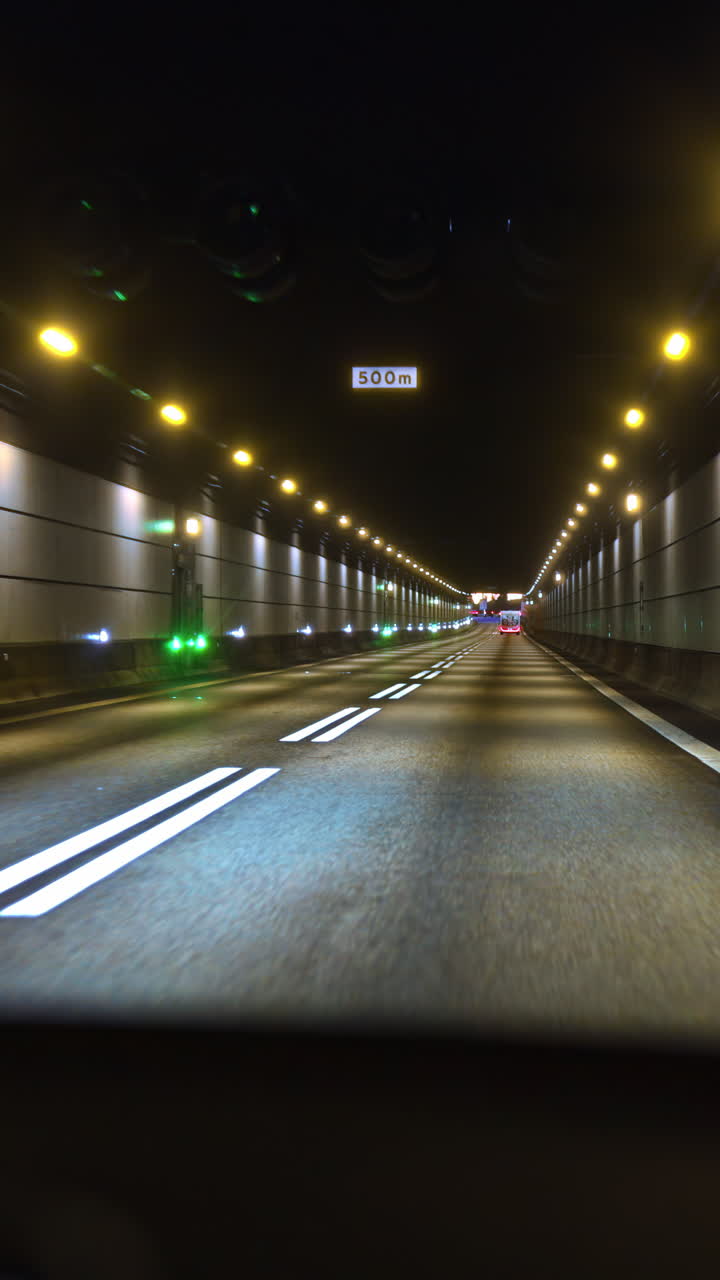 A drive through a illuminated tunnel in Copenhagen, Denmark. Vertical