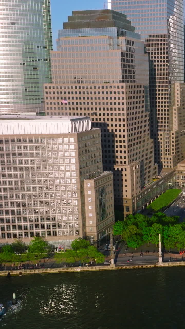 Little yachts dock near Manhattan Island. Skyscrapers shining in the sun at the backdrop of beautiful light blue sky. Vertical video