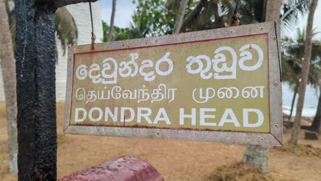 sign for dondra head lighthouse at southernmost point of sri lanka in tamil, sinhala, and english language
