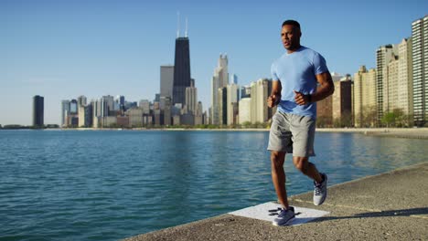 ethnic male doing cardio workout with smart watch