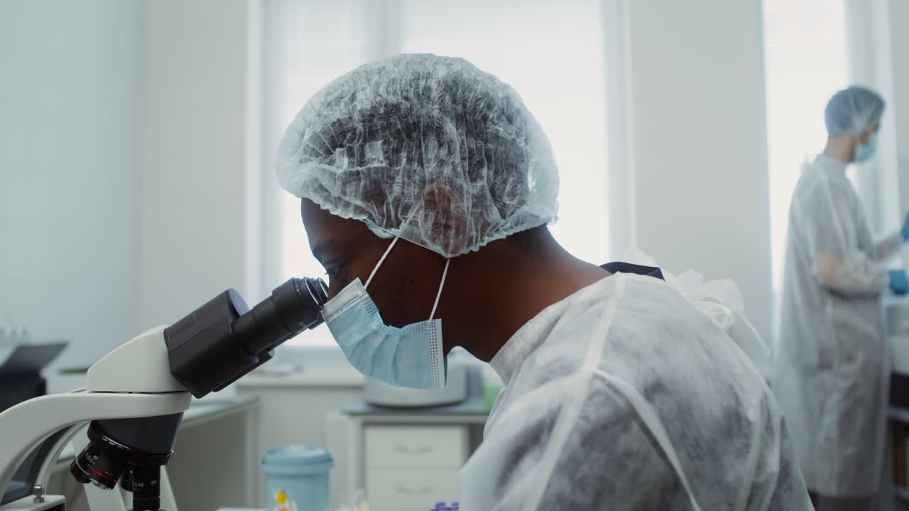 Scientist using a microscope in a laboratory setting