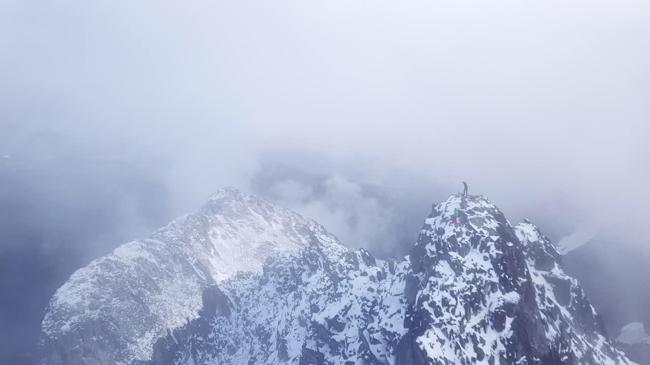 Hikers standing on top of a peak in the coast mountains of Canada