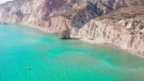 Firiplaka-or-Fyriplaka-beach-aerial,-seaside-majestic-towering-volcanic-cliffs,-Greece-travel-destination