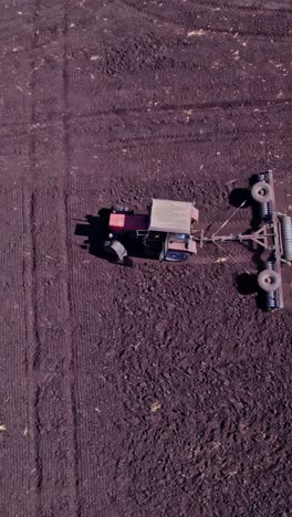 tractor tilling center of farm field in the fall
