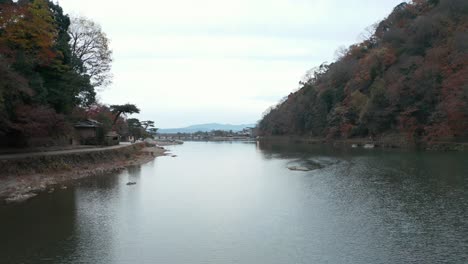 arashiyama slow pullback shot, katsura river and togetsukyo bridge in background