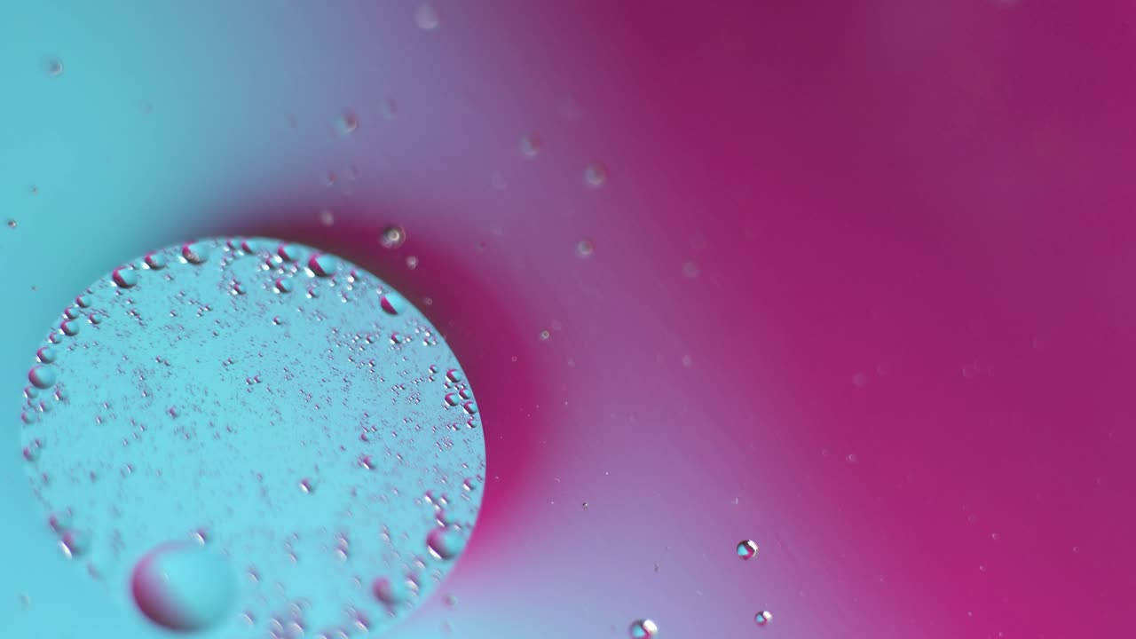 Neon purple and blue gradient. Macro oil drop in water. Real holographic liquid background