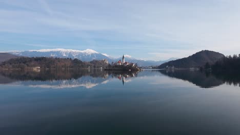 Aerial-shot-of-Bled-lake-through-trees-in-Slovenia