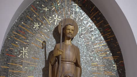 sculpture of saint with mosaic halo. religious site