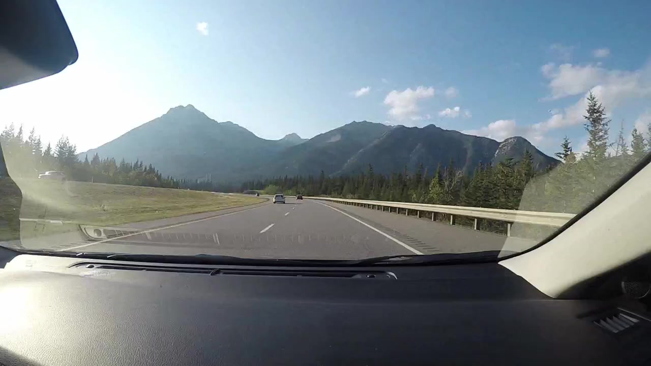 Timelapse drive from flat landscape into the mountains