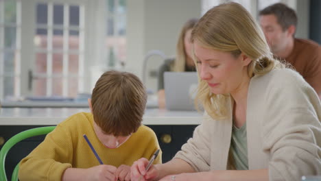 Mutter-Hilft-Sohn-Bei-Den-Hausaufgaben,-Sitzt-Zu-Hause-Mit-Laptop-Am-Küchentisch-–-Aufnahme-In-Zeitlupe