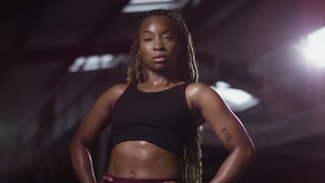 studio portrait of woman wearing fitness clothing standing in gym 1