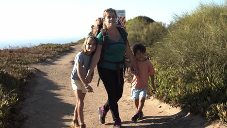 happy children and mom wearing backpack