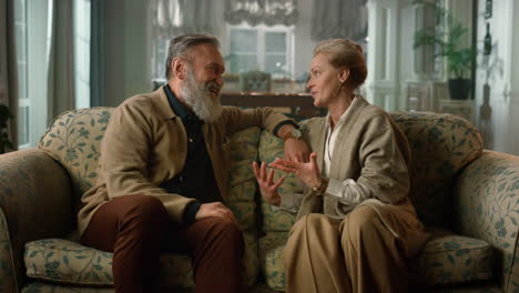 cheerful elderly couple talking at luxury home