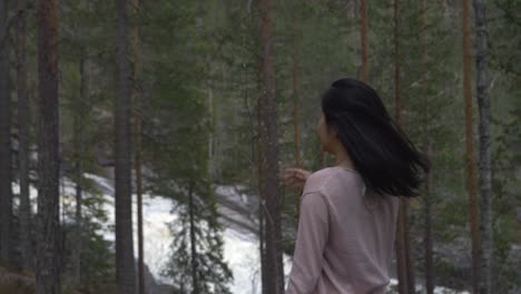 Girl-in-forest-playin-with-hair-and-spinning,-slowmotion