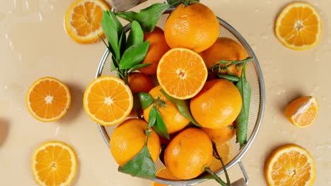 ripe tangerines in a colander slowly rotate.