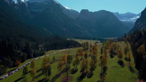 Vibrant-maple-trees-with-colorful-red-and-yellow-fall-leaves-in-sunny-autumn-in-the-alps-mountains-in-Tyrol,-Austria-at-scenic-Ahornboden-forest-at-Rissach-Engtal-tourist-travel-spot