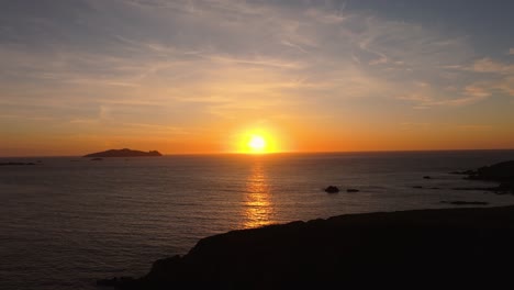 golden sunset light over dunquin pier, with dramatic skies and sea views - dingle co.kerry - 4k cinematic drone footage 13