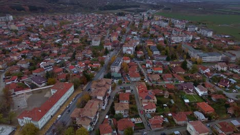 a beautiful aerial view of sopot, a charming bulgarian town at the foot of the balkan mountains, showcasing the town, flying from its center towards the east side where it meets the town of karlovo