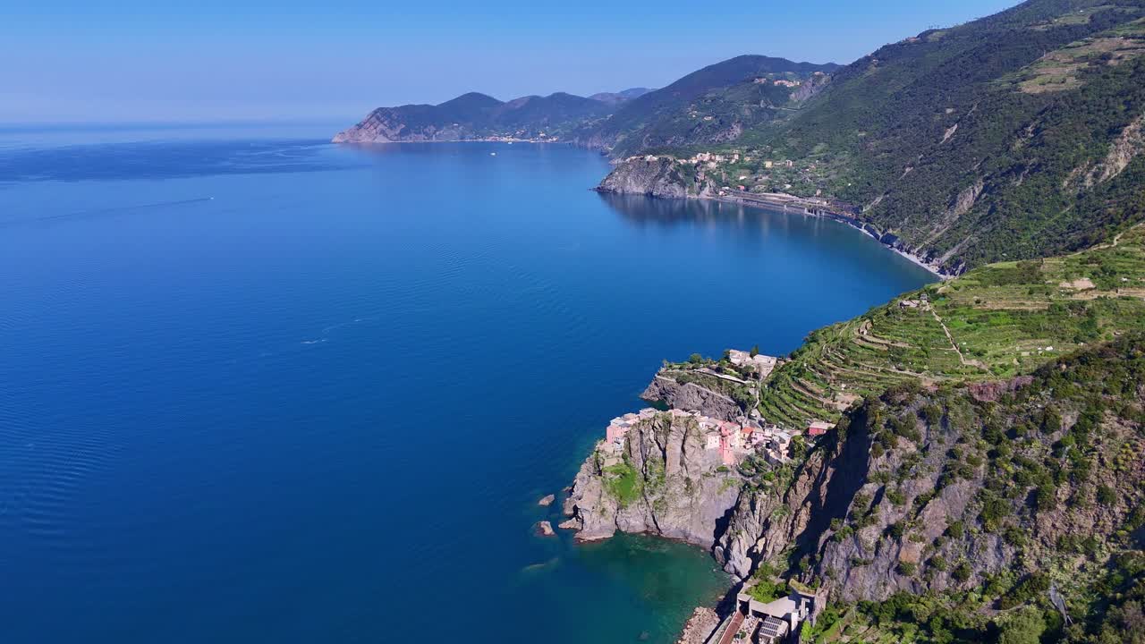 Drone footage of the coast of Cinque Terre in Italy with small villages.