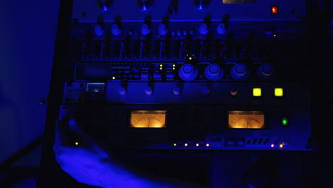 audio engineer working in a recording studio at night