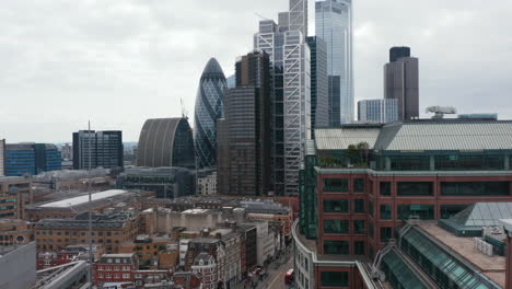 Ascending-footage-of-urban-district.-Revealing-of-skyscrapers-in-City-financial-hub.-Glossy-glass-luxurious-tall-buildings.-London,-UK