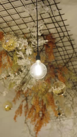 vertical - bright retro style light bulb hang from ceilings in coffee shop