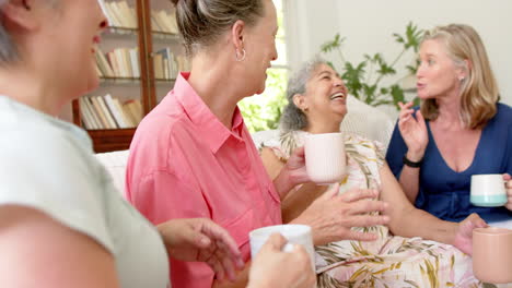 senior diverse group of women share a laugh at home