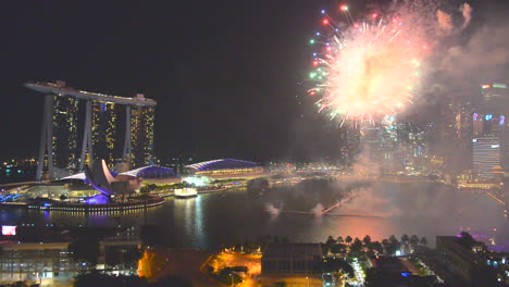 A-night-shot-of-fireworks-display-near-Marina-bay-sand-building,-Singapore