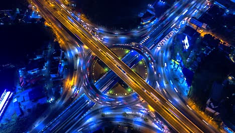 blur aerial view of traffic on circle and freeway and interchange at night