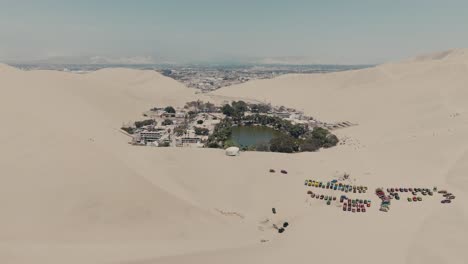 huacachina oasis at ica desert with hotels in peru. - aerial shot
