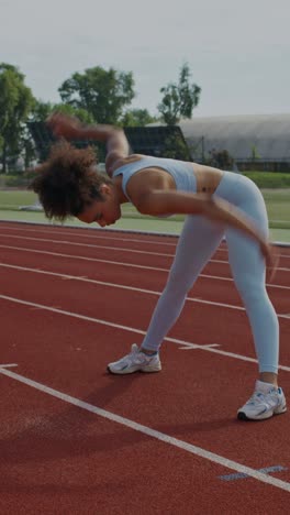 woman stretching on a track