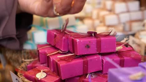 woman shopping for handmade soap at a craft market