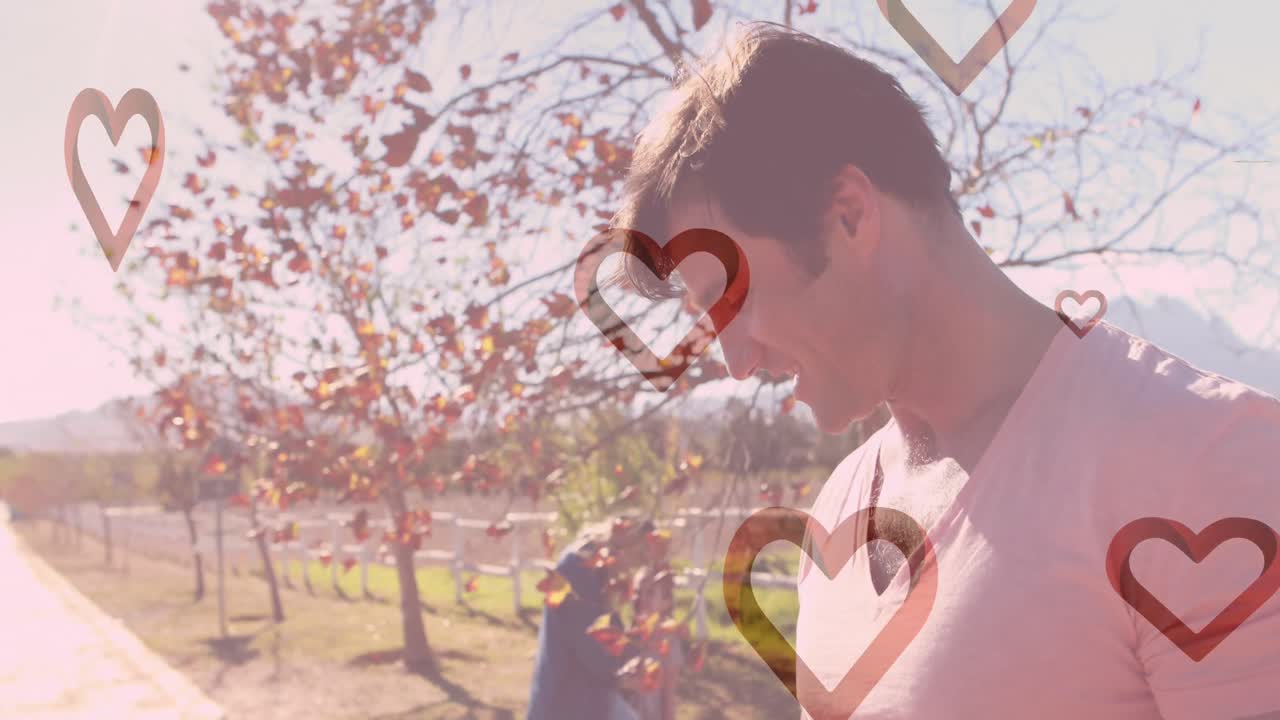 공원에서 백인 가족을 향해 떨어지는 심장의 애니메이션