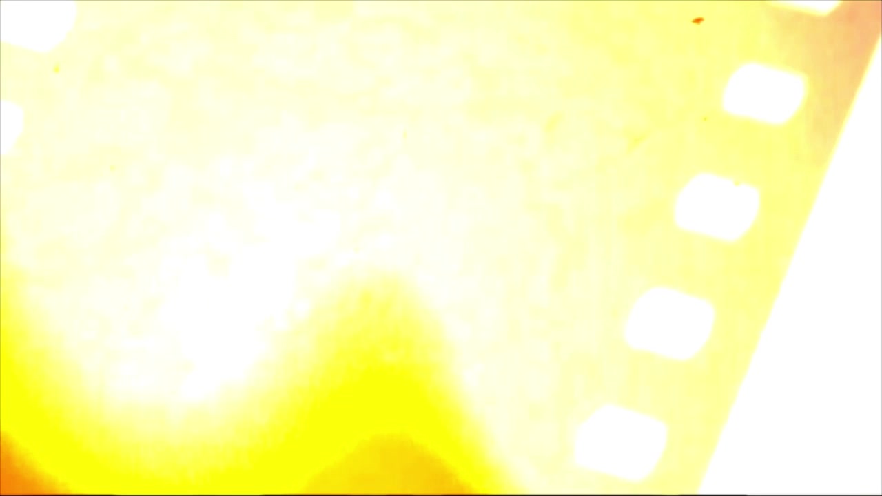 Abstract Moving Film Strip with Yellow Light Leak