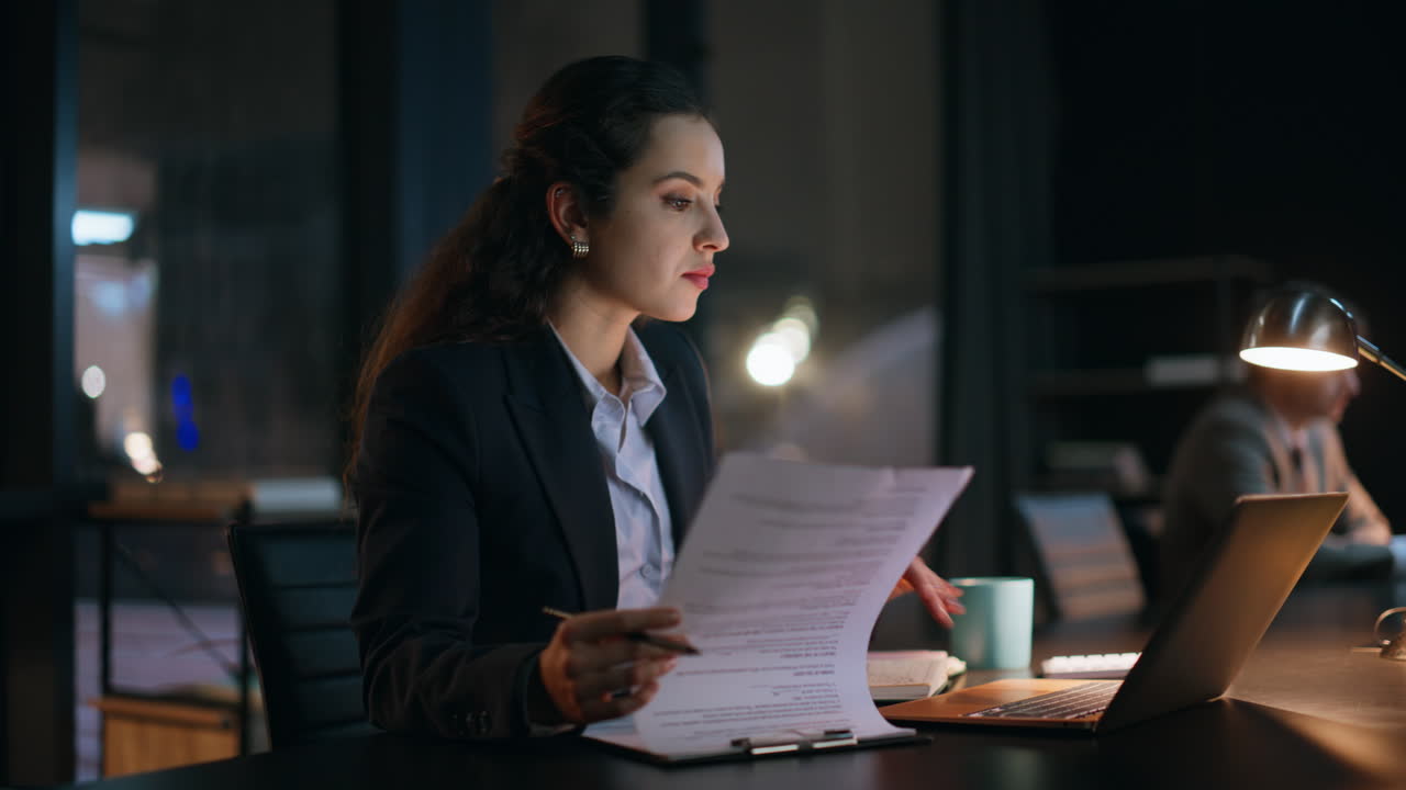 Night businesswoman reviewing documents at dark office closeup. Excited lady