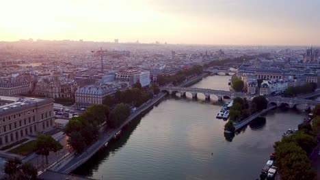 descending drone flying over seine river in paris towards ile de la cite and la samaritaine in reconstruction