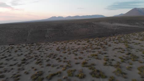 aerial cinematic approach of a canyon in atacama desert at sunset