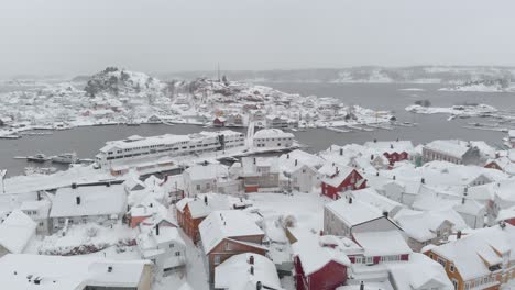 Kragero,-Telemark-County,-Norway---A-Picturesque-Town-Blanketed-in-Snow-on-a-Winter-Day---Drone-Flying-Forward