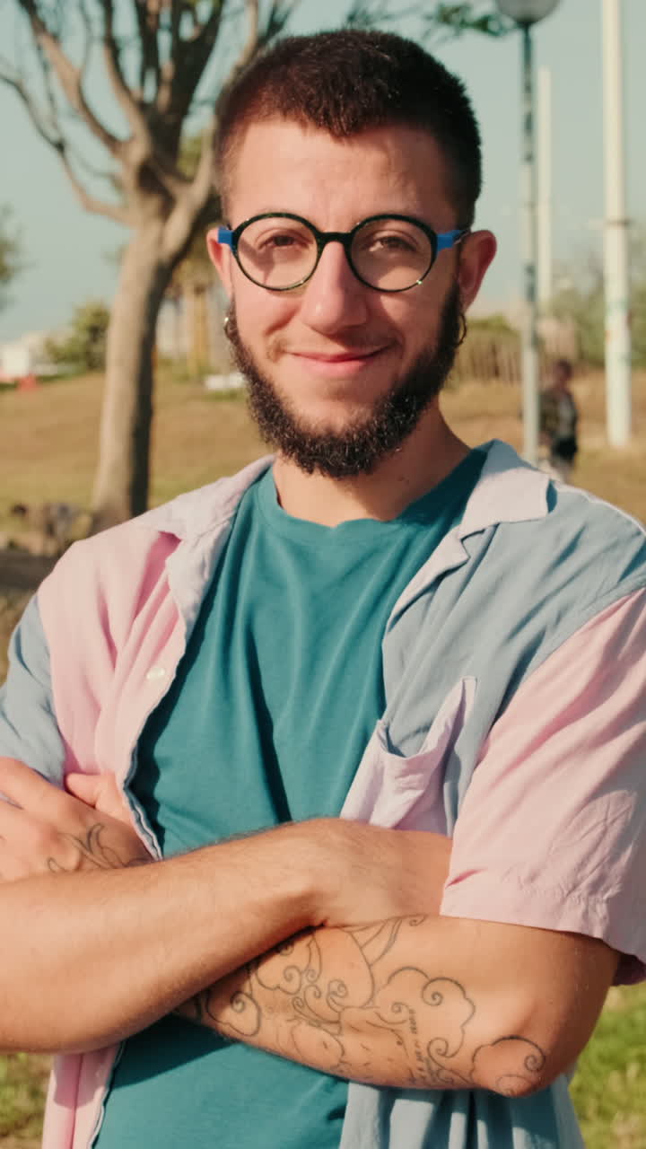 Man Smiling at Camera With Friends in Park